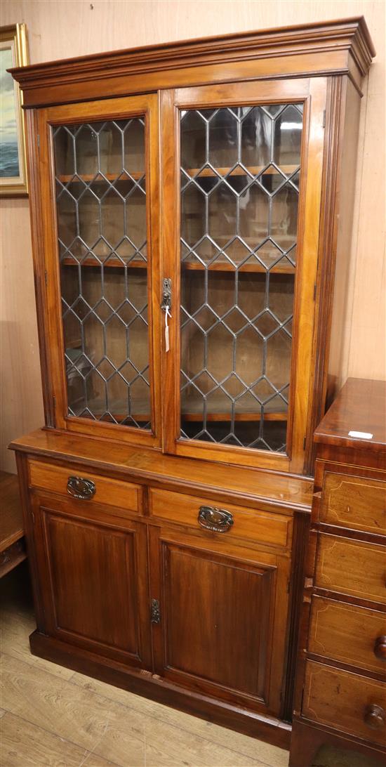 A late Victorian glazed walnut bookcase cupboard W.103cm